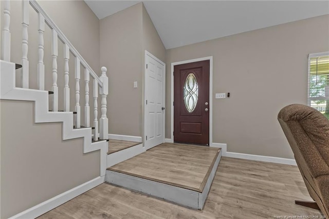 300 Fox Ridge Rd, Warsaw, NC 28398 - foyer entrance featuring wood finished floors, baseboards, stairway, and lofted ceiling