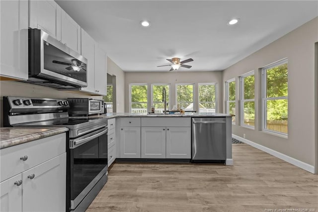 300 Fox Ridge Rd, Warsaw, NC 28398 - kitchen featuring appliances with stainless steel finishes, ceiling fan, a peninsula, healthy amount of natural light, and recessed lighting