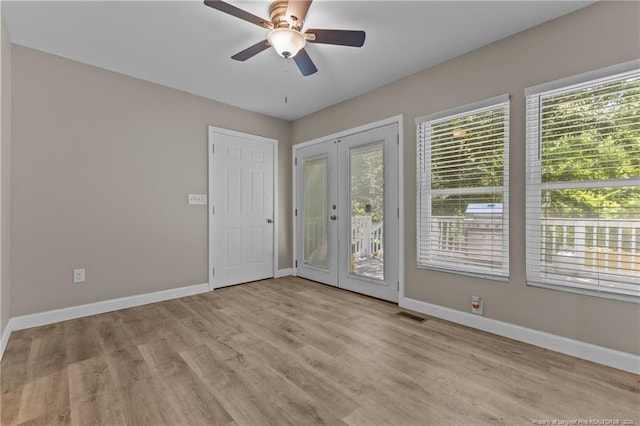 300 Fox Ridge Rd, Warsaw, NC 28398 - empty room with baseboards, a ceiling fan, light wood-style flooring, and french doors
