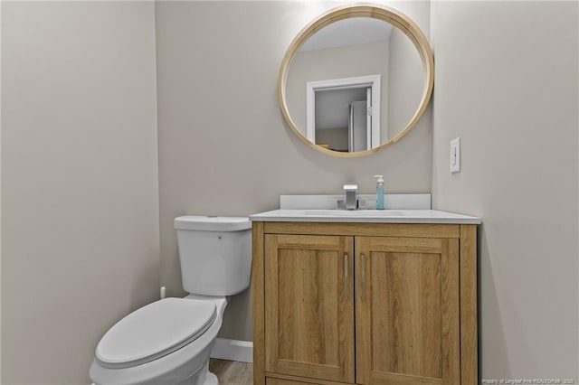 300 Fox Ridge Rd, Warsaw, NC 28398 - bathroom featuring vanity, toilet, and wood finished floors