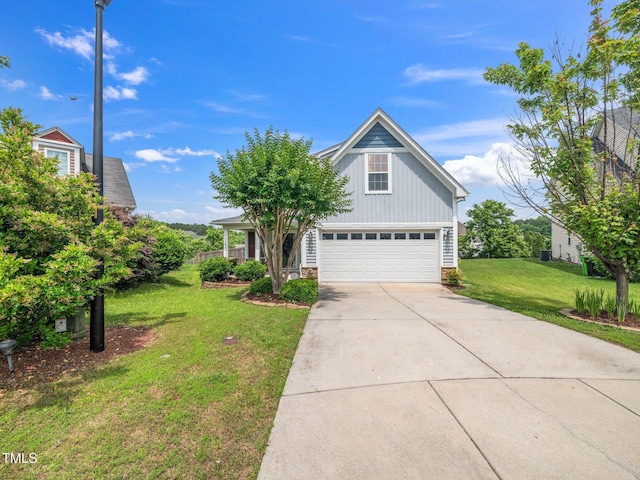 4502 Joe Cotton Dr, Knightdale, NC 27545 - traditional home with a front yard, driveway, an attached garage, stone siding, and board and batten siding