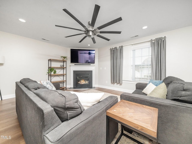 4502 Joe Cotton Dr, Knightdale, NC 27545 - living room featuring ceiling fan, light wood-type flooring, baseboards, recessed lighting, and a glass covered fireplace
