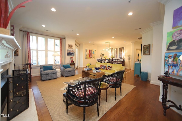 2901 Market Bridge Ln Unit 203, Raleigh, NC 27608 - dining area featuring crown molding, wood finished floors, baseboards, a chandelier, and a fireplace
