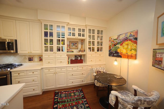 2901 Market Bridge Ln Unit 203, Raleigh, NC 27608 - kitchen with appliances with stainless steel finishes, white cabinets, glass insert cabinets, and light countertops