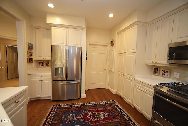 2901 Market Bridge Ln Unit 203, Raleigh, NC 27608 - kitchen with stainless steel appliances, dark wood-style floors, white cabinets, and recessed lighting
