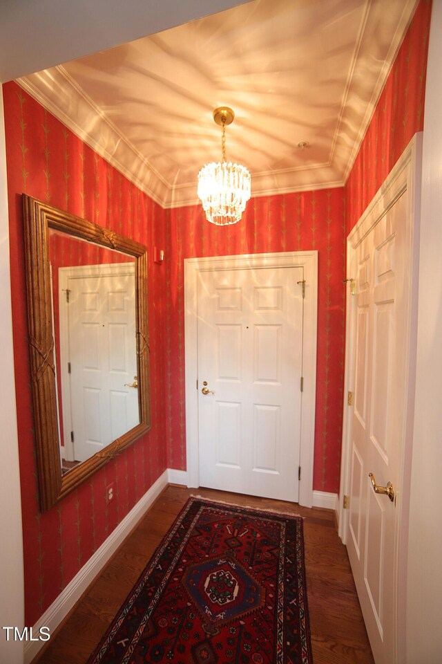 2901 Market Bridge Ln Unit 203, Raleigh, NC 27608 - doorway to outside featuring a chandelier, wood finished floors, baseboards, and ornamental molding