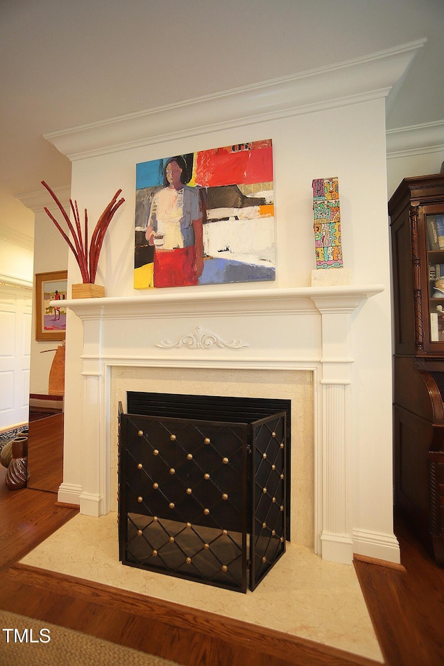 2901 Market Bridge Ln Unit 203, Raleigh, NC 27608 - detailed view of crown molding, wood finished floors, and a fireplace with flush hearth