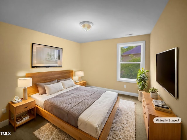 bedroom with baseboards and carpet flooring