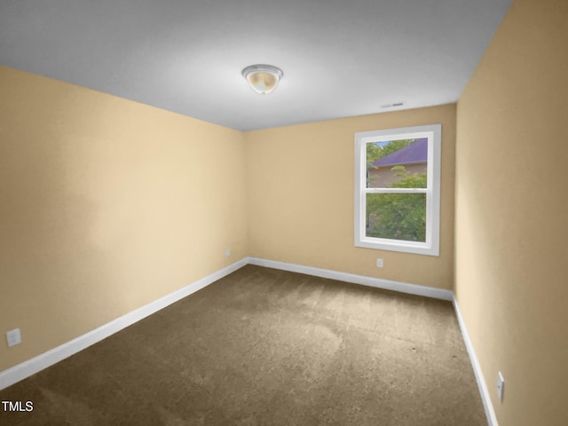 unfurnished room with carpet flooring and baseboards