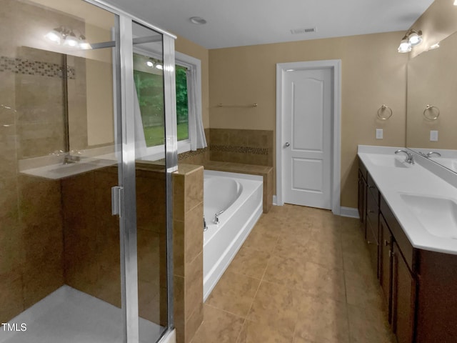 bathroom with a garden tub, tile patterned floors, a stall shower, and double vanity