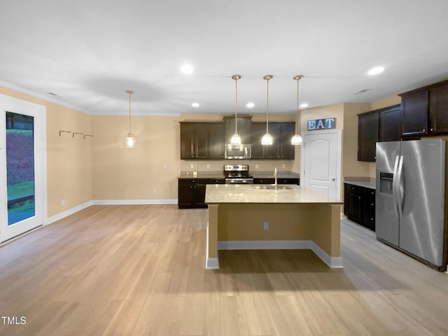 kitchen with appliances with stainless steel finishes, a sink, light wood-type flooring, baseboards, and recessed lighting