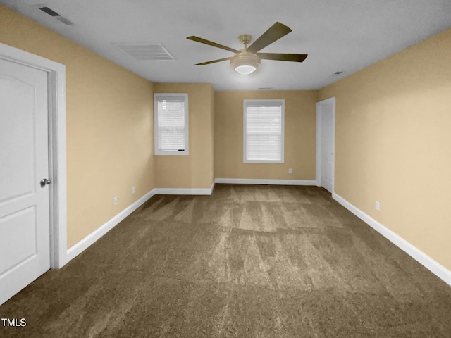 empty room with carpet, ceiling fan, and baseboards