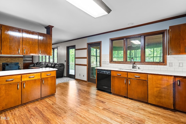 1608 New Hill Olive Chapel Rd, Apex, NC 27502 - kitchen featuring black dishwasher, a sink, crown molding, light countertops, and brown cabinetry