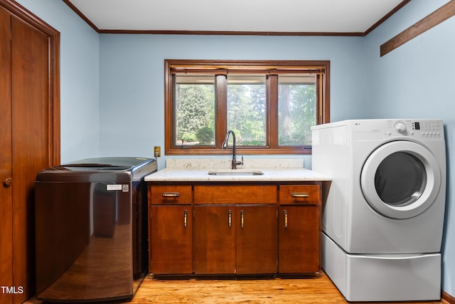 1608 New Hill Olive Chapel Rd, Apex, NC 27502 - laundry area featuring crown molding, cabinet space, washer and dryer, and light wood finished floors