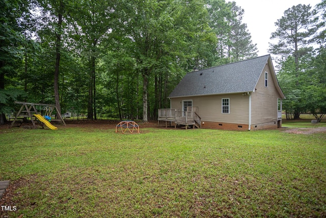 129 Clark Ct, Youngsville, NC 27596 - view of grassy yard with a wooden deck and a playground