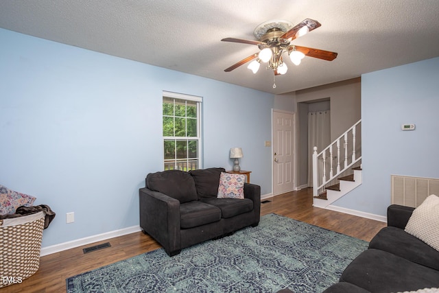 129 Clark Ct, Youngsville, NC 27596 - living area with stairway, a ceiling fan, wood finished floors, baseboards, and a textured ceiling
