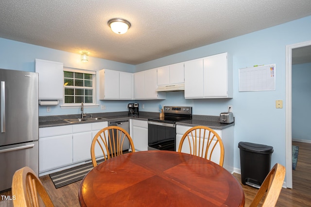 129 Clark Ct, Youngsville, NC 27596 - kitchen with stainless steel appliances, a sink, dark wood-style flooring, white cabinets, and a textured ceiling