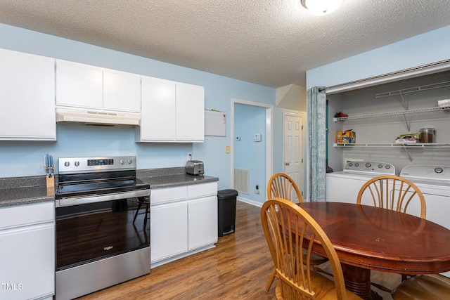 129 Clark Ct, Youngsville, NC 27596 - kitchen with electric stove, under cabinet range hood, washing machine and dryer, wood finished floors, and white cabinetry