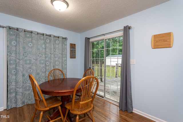 129 Clark Ct, Youngsville, NC 27596 - dining room featuring wood finished floors, a textured ceiling, and baseboards
