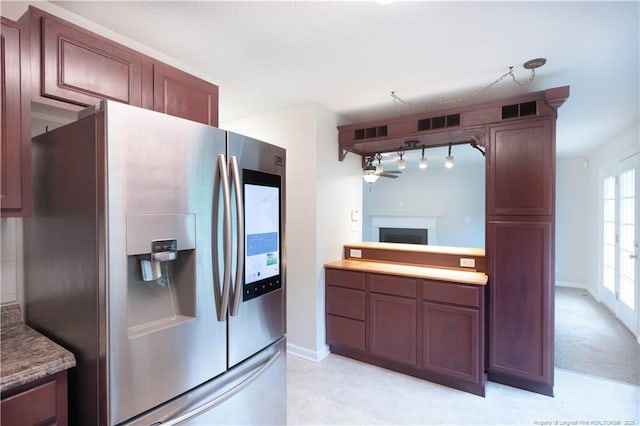 109 Sand Dollar Ct, Raeford, NC 28376 - kitchen with stainless steel refrigerator with ice dispenser, track lighting, a fireplace, and baseboards