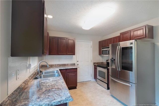109 Sand Dollar Ct, Raeford, NC 28376 - kitchen with appliances with stainless steel finishes, a sink, a textured ceiling, backsplash, and light floors