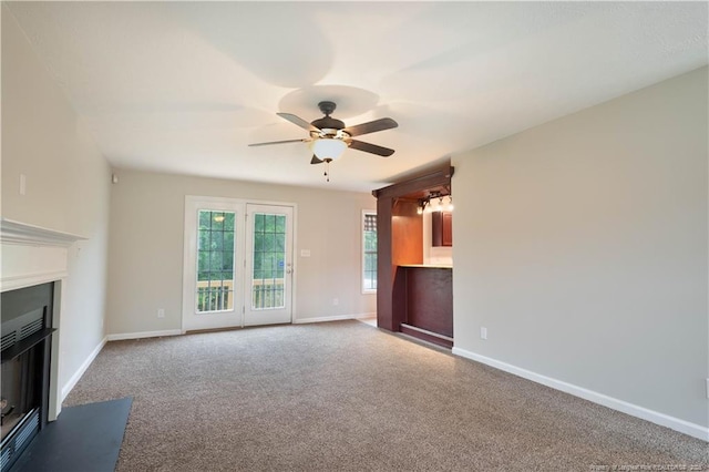109 Sand Dollar Ct, Raeford, NC 28376 - unfurnished living room with a glass covered fireplace, carpet, a ceiling fan, and baseboards