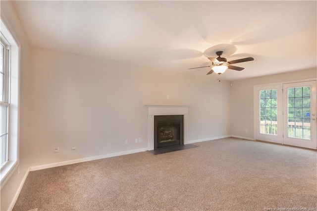 109 Sand Dollar Ct, Raeford, NC 28376 - unfurnished living room with light colored carpet, a ceiling fan, a fireplace with flush hearth, and baseboards