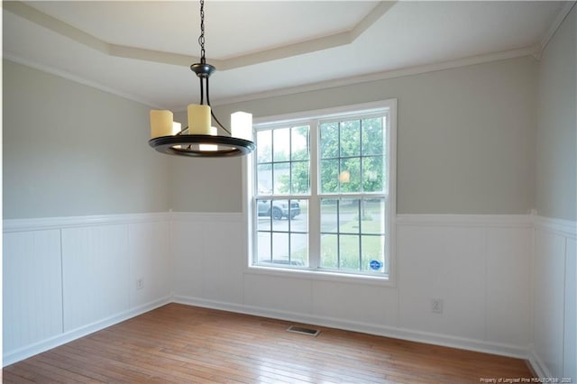 109 Sand Dollar Ct, Raeford, NC 28376 - unfurnished room featuring a chandelier, hardwood / wood-style flooring, a wainscoted wall, a decorative wall, and a raised ceiling