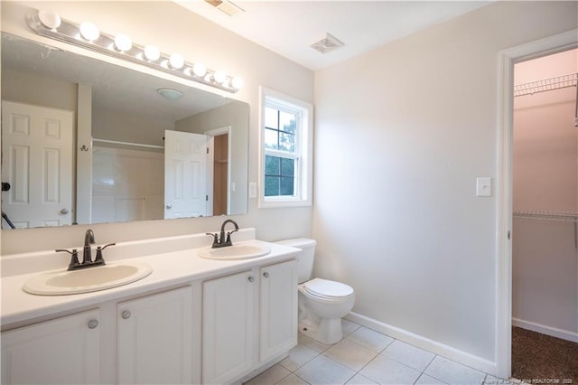 109 Sand Dollar Ct, Raeford, NC 28376 - full bathroom featuring toilet, tile patterned floors, double vanity, baseboards, and a spacious closet