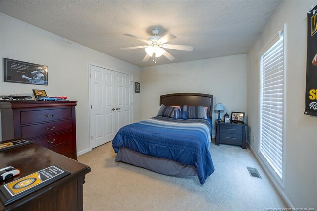 430 Rose Rd, Newton Grove, NC 28366 - bedroom with light colored carpet, a ceiling fan, and a closet