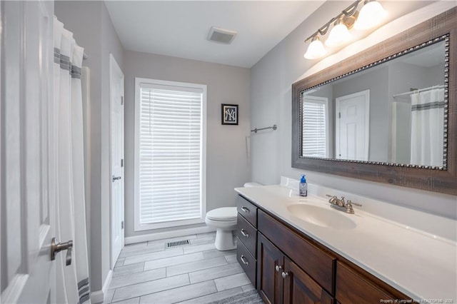 430 Rose Rd, Newton Grove, NC 28366 - full bath featuring vanity, toilet, wood tiled floors, and baseboards
