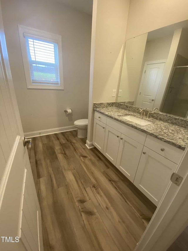 400 Access Dr, Youngsville, NC 27596 - bathroom featuring vanity, toilet, wood finished floors, a shower with shower door, and baseboards