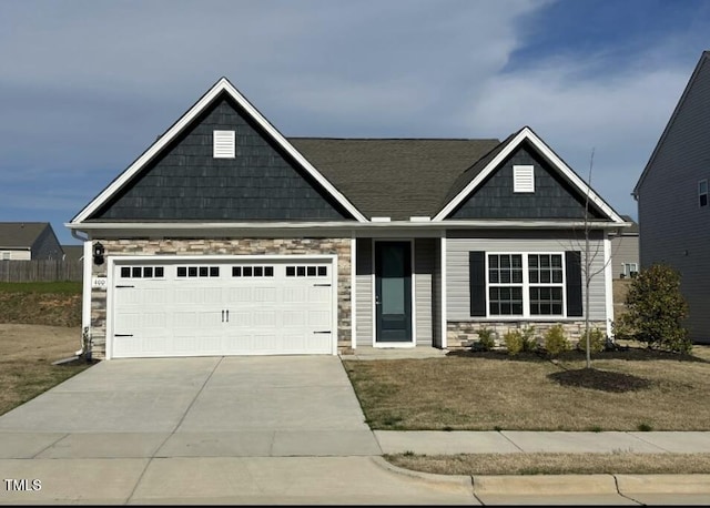 400 Access Dr, Youngsville, NC 27596 - craftsman-style house featuring stone siding, driveway, an attached garage, and a front yard
