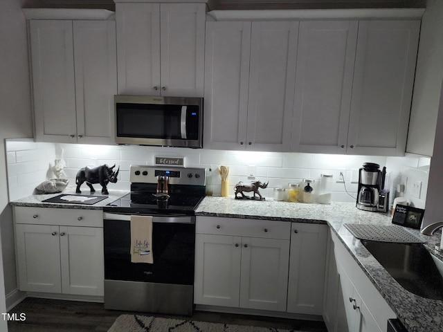 400 Access Dr, Youngsville, NC 27596 - kitchen featuring stainless steel appliances, backsplash, and white cabinetry