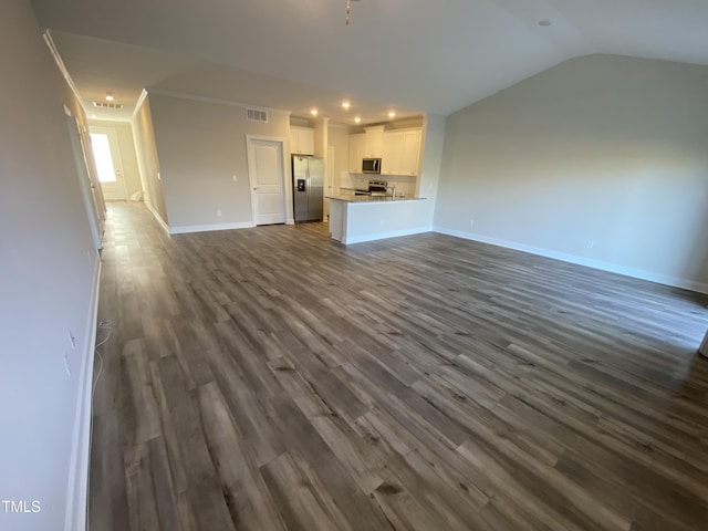 400 Access Dr, Youngsville, NC 27596 - unfurnished living room with baseboards, dark wood-type flooring, recessed lighting, ornamental molding, and vaulted ceiling