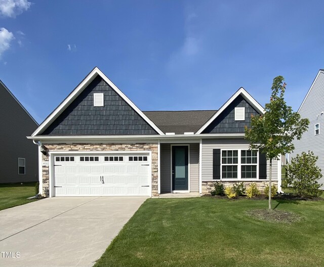 400 Access Dr, Youngsville, NC 27596 - craftsman-style house featuring stone siding, concrete driveway, a front yard, and a garage