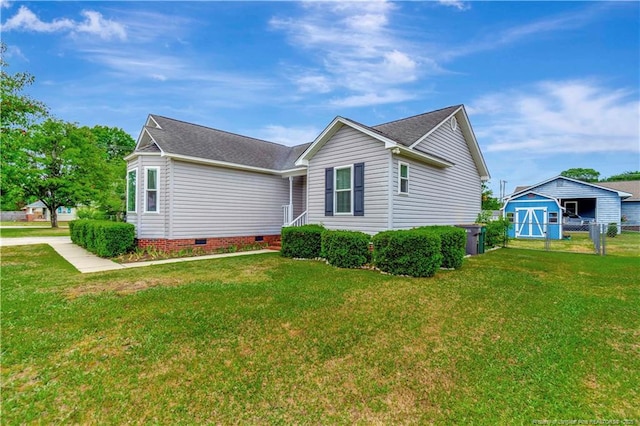 1501 E 6th St, Lumberton, NC 28358 - view of front of property with crawl space, a shingled roof, an outdoor structure, and a storage unit