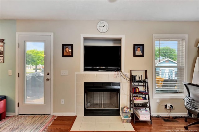 1501 E 6th St, Lumberton, NC 28358 - living room featuring plenty of natural light, a tile fireplace, and wood finished floors