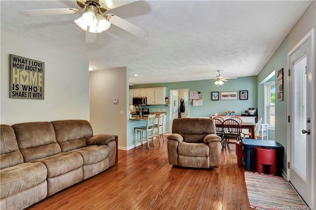1501 E 6th St, Lumberton, NC 28358 - living area with ceiling fan, light wood finished floors, and a textured ceiling