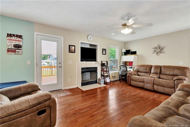 1501 E 6th St, Lumberton, NC 28358 - living room featuring ceiling fan, wood finished floors, a fireplace, and baseboards