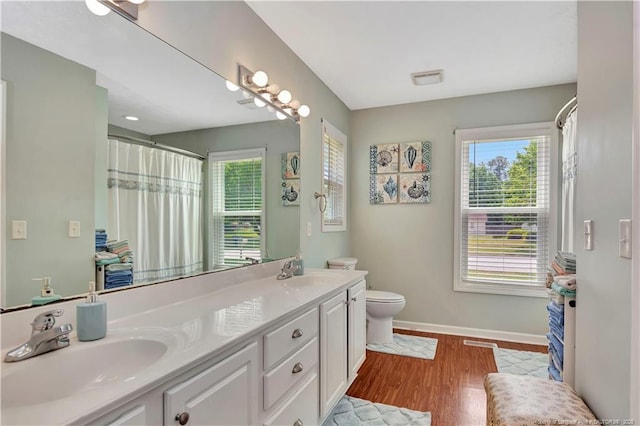 1501 E 6th St, Lumberton, NC 28358 - full bath with baseboards, wood finished floors, toilet, and double vanity