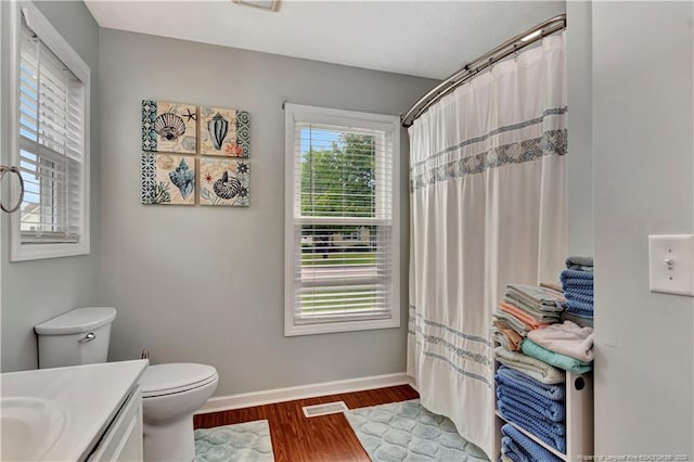 1501 E 6th St, Lumberton, NC 28358 - bathroom featuring wood finished floors, toilet, baseboards, vanity, and curtained shower