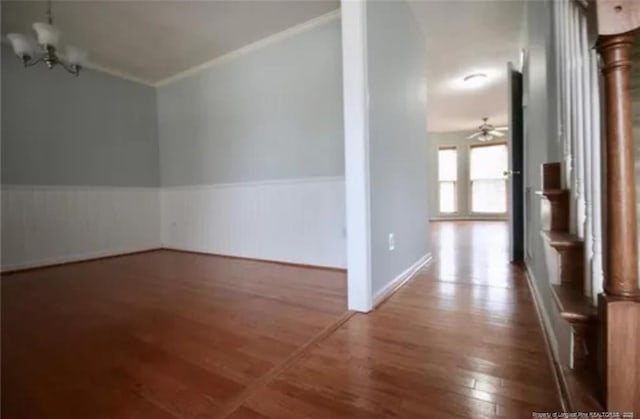 bonus room featuring wood finished floors, a wainscoted wall, and baseboards