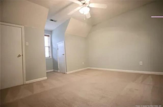 bonus room with light carpet, ceiling fan, baseboards, and vaulted ceiling