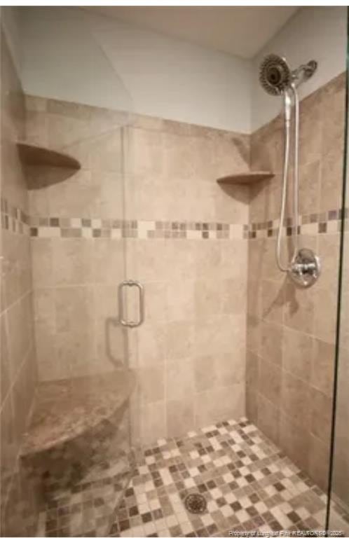 full bath with a shower stall