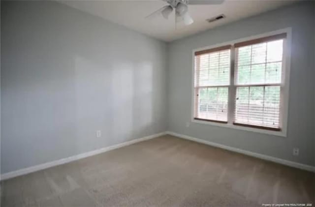 unfurnished room with baseboards, ceiling fan, and carpet floors