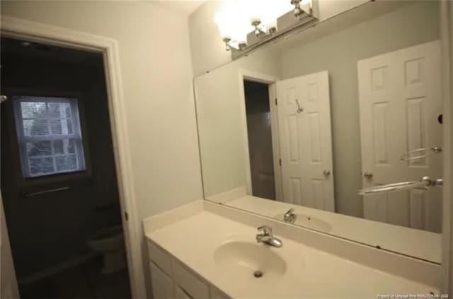 bathroom with toilet and vanity