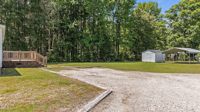 4870 Dogwood Dr, Battleboro, NC 27809 - view of green lawn featuring a storage unit, an outbuilding, and a carport