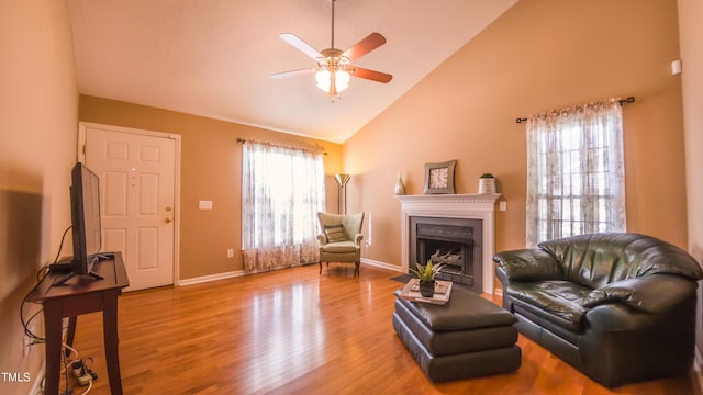 133 Parkhaven Ln, Garner, NC 27529 - living area featuring ceiling fan, wood finished floors, baseboards, a fireplace with flush hearth, and high vaulted ceiling