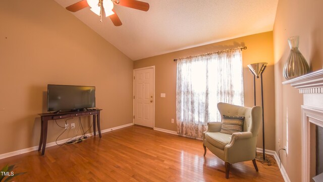 133 Parkhaven Ln, Garner, NC 27529 - sitting room with wood finished floors, a ceiling fan, lofted ceiling, baseboards, and a glass covered fireplace